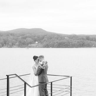 bride and groom by lake