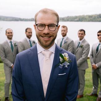 smiling groom with groomsmen