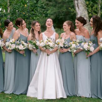 bridal party and bride laughing