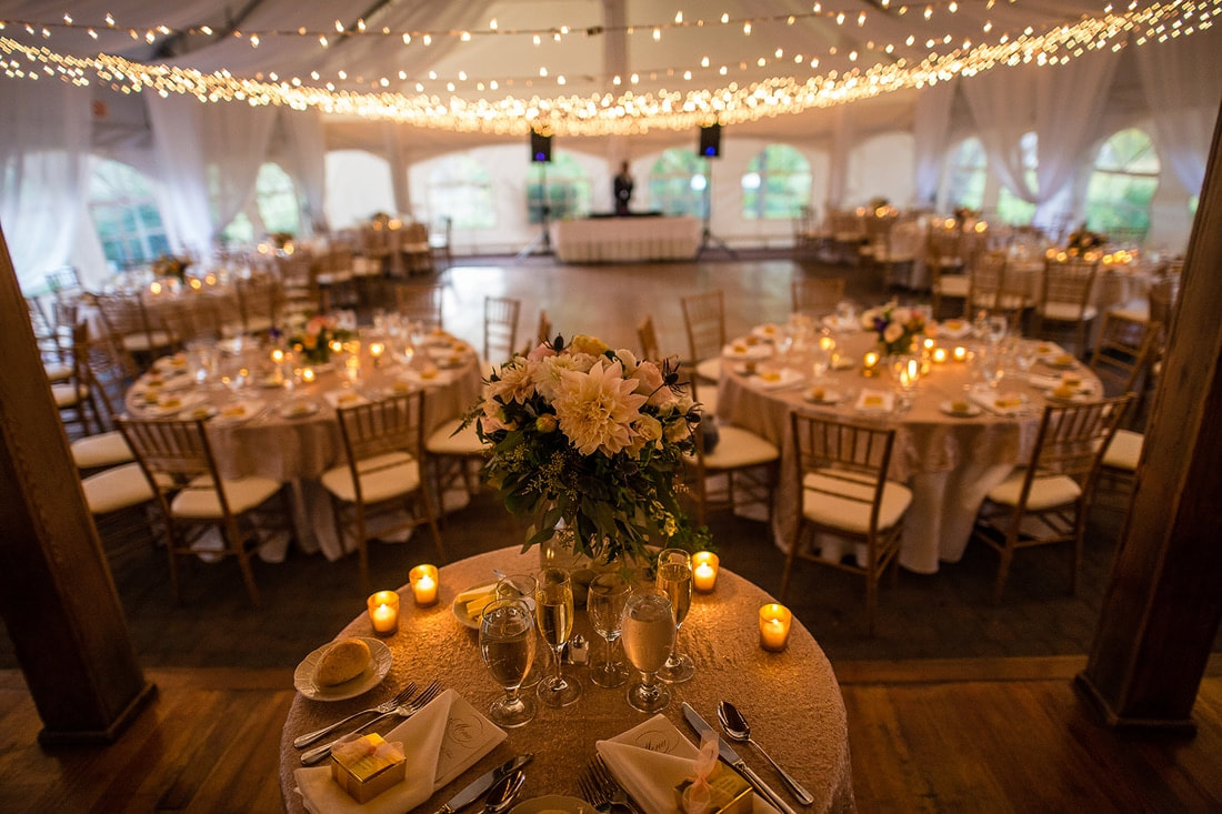 tent with fairy lights and candle lit tables with fancy table settings